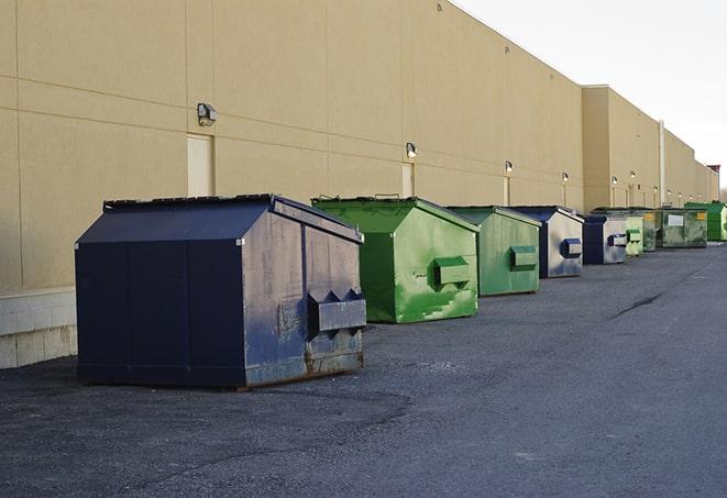 a row of construction dumpsters parked on a jobsite in Bayside